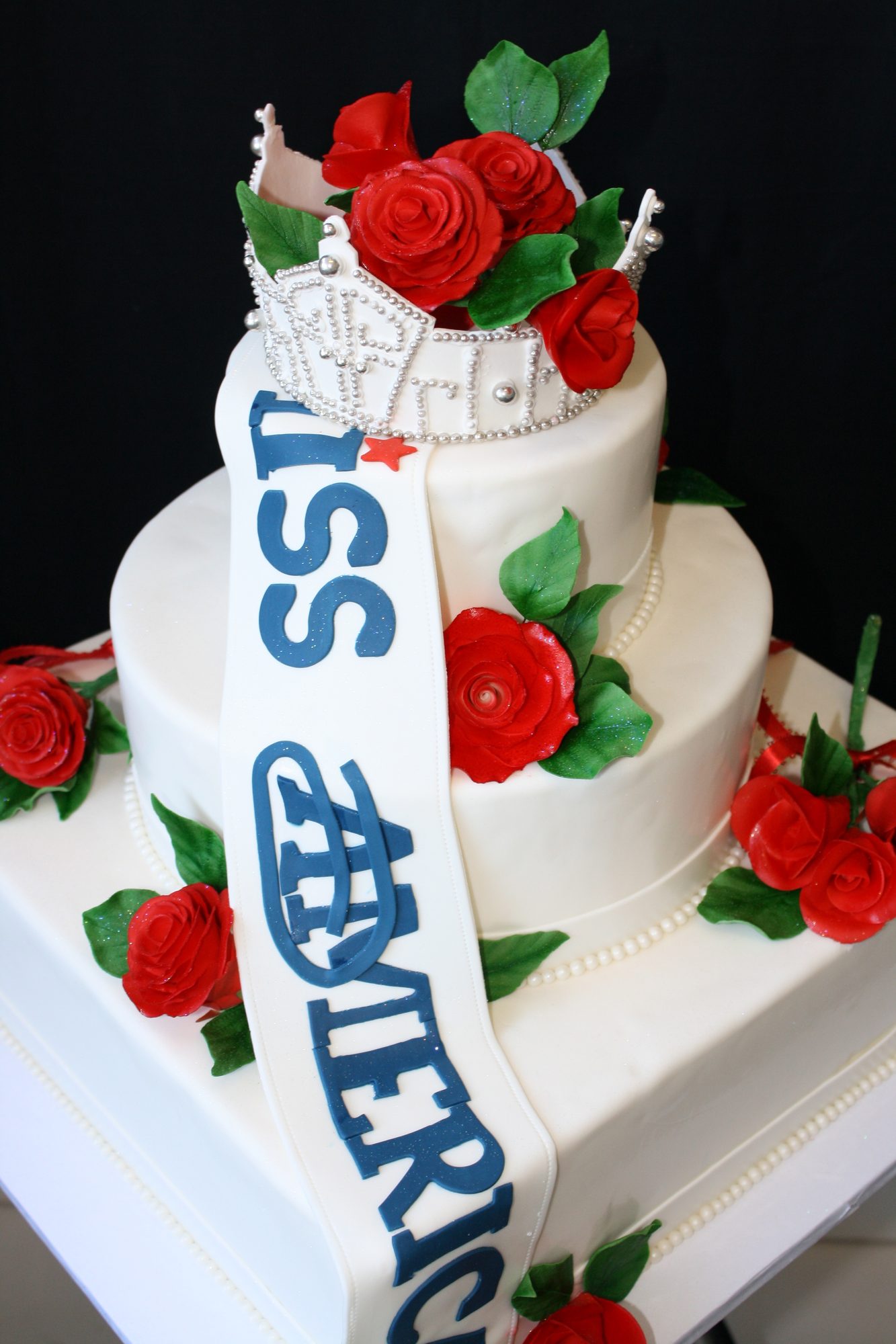 Miss America pageant cake with sugar roses and sash
